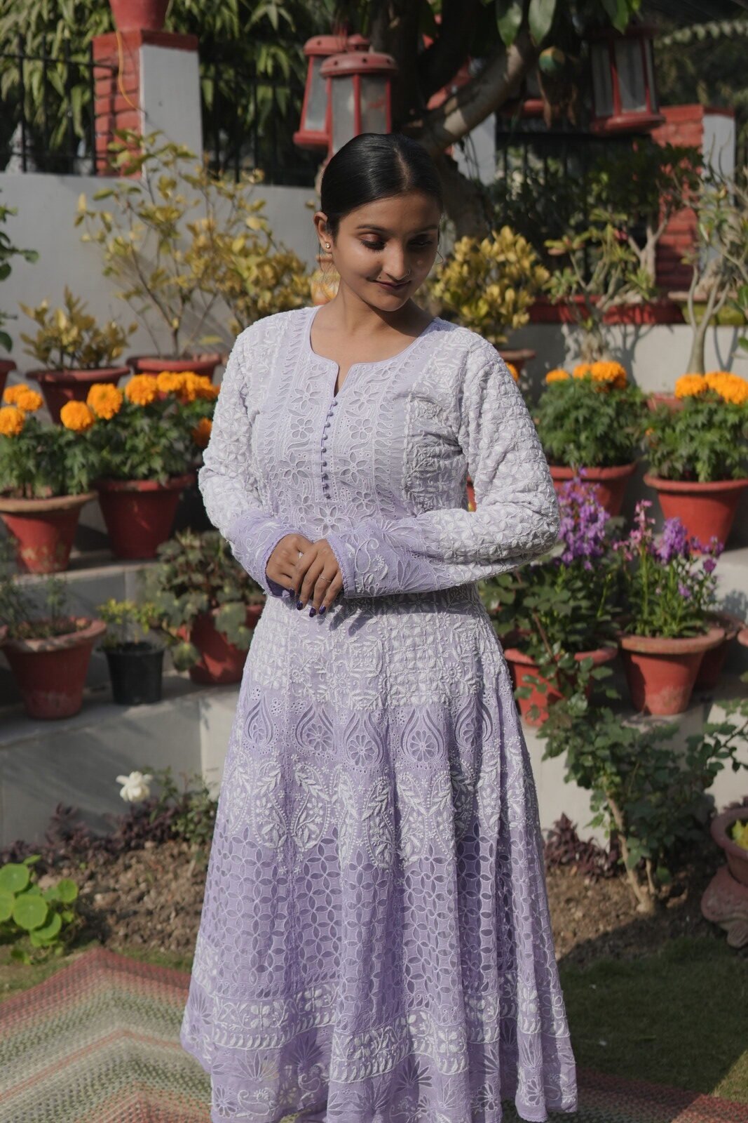 DSC09297 Woman in purple dress among flowers.