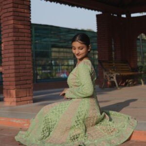 Woman in green traditional attire.