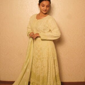 Woman in elegant traditional light green attire.