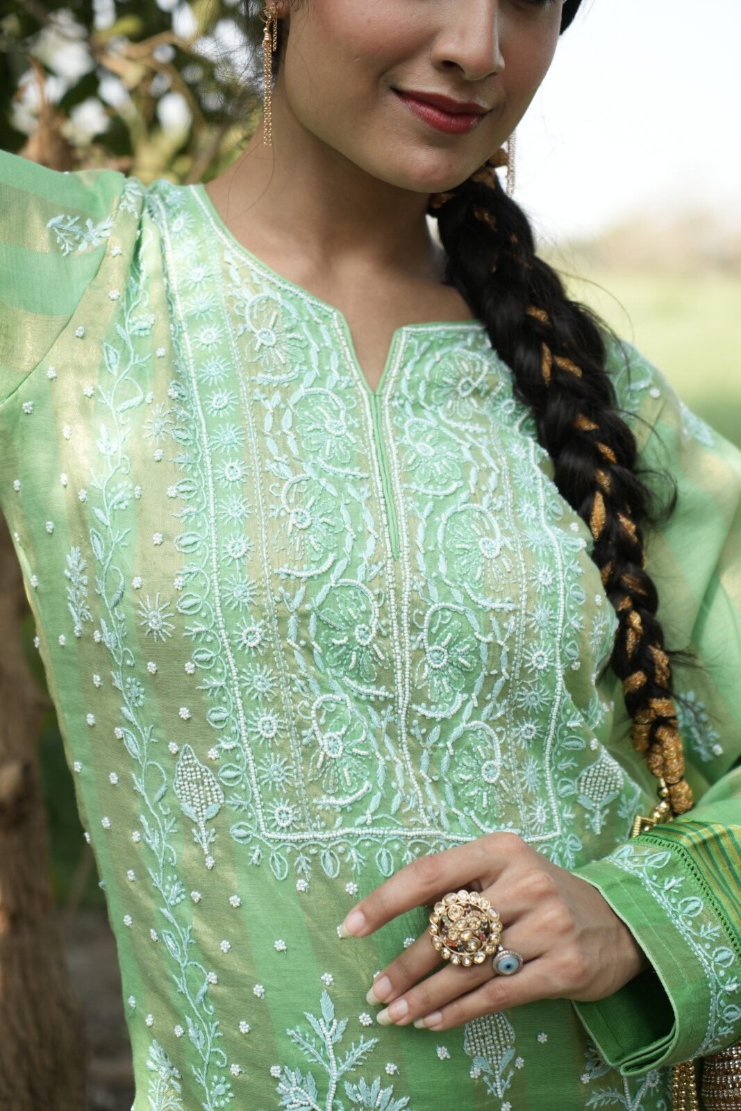 Coverpic Woman in green embroidered outfit