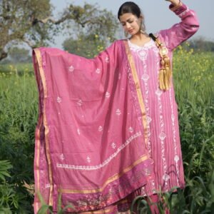 Person in traditional pink attire outdoors