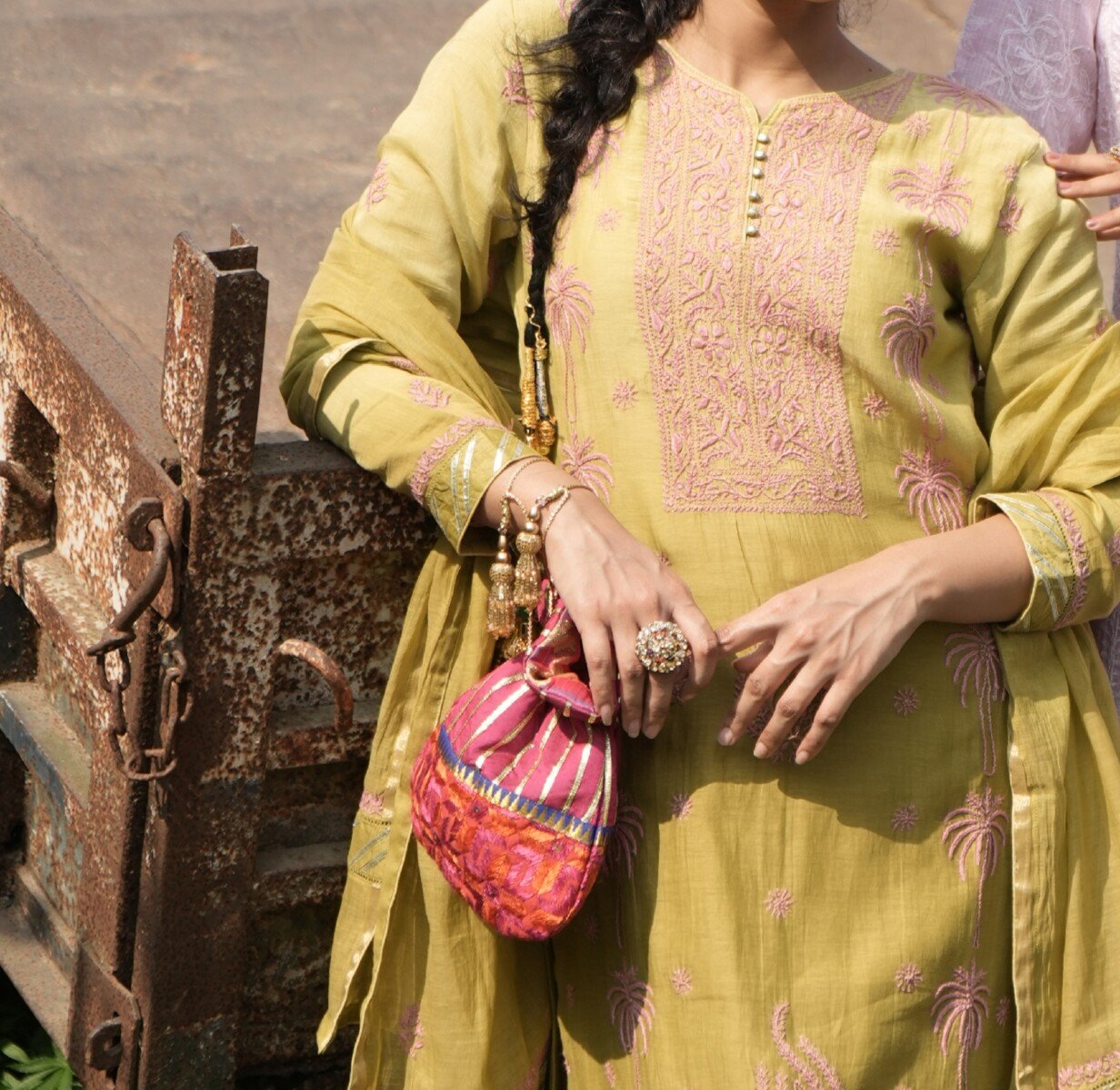 cover Woman in traditional attire with bag